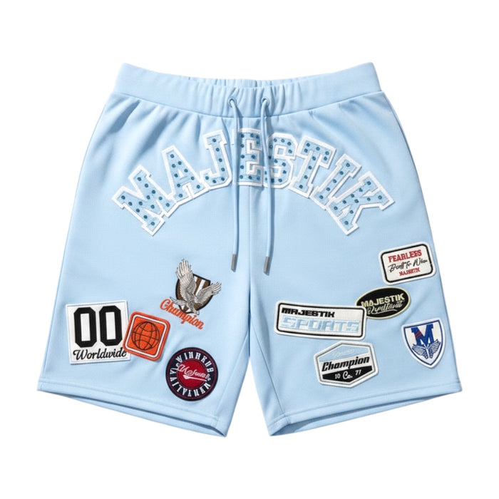 Light blue Majestik Champion rhinestone rugby patched shorts with decorative patches and detailed stitching.