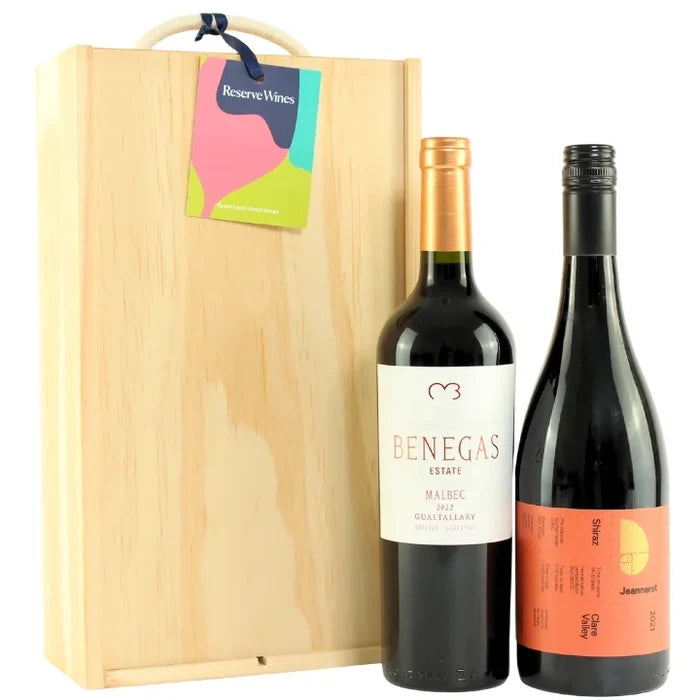 Two wine bottles with labels in front of a wooden gift box, featuring Reserve Wines branding.