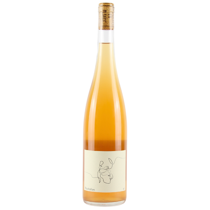 A bottle of Charles Frey Maceration 2023 orange wine with a label depicting a stylized grapevine. The wine appears golden in color.