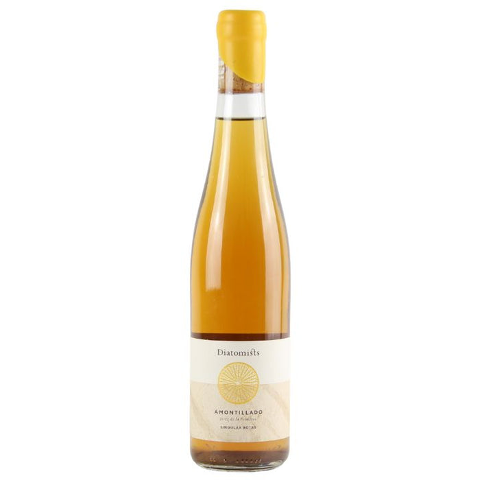 A bottle of Diatomists Amontillado Sherry with a yellow label and a protective cap on top. The text on the label includes 'Diatomists' and 'Amontillado'