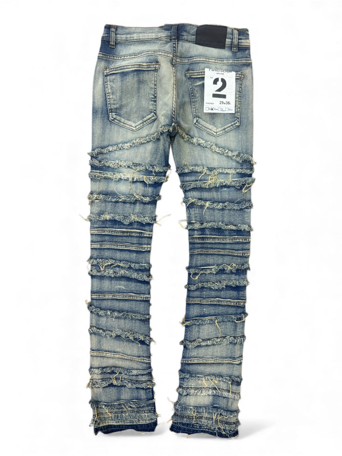 Light wash FWRD distressed frayed stacked denim jeans with a relaxed fit and frayed hem, showcased on a model.