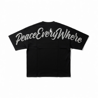 Inner Peace black oversized rhinestone T-shirt with "Peace Everywhere" design, showcasing bold, sparkling embellishments.
