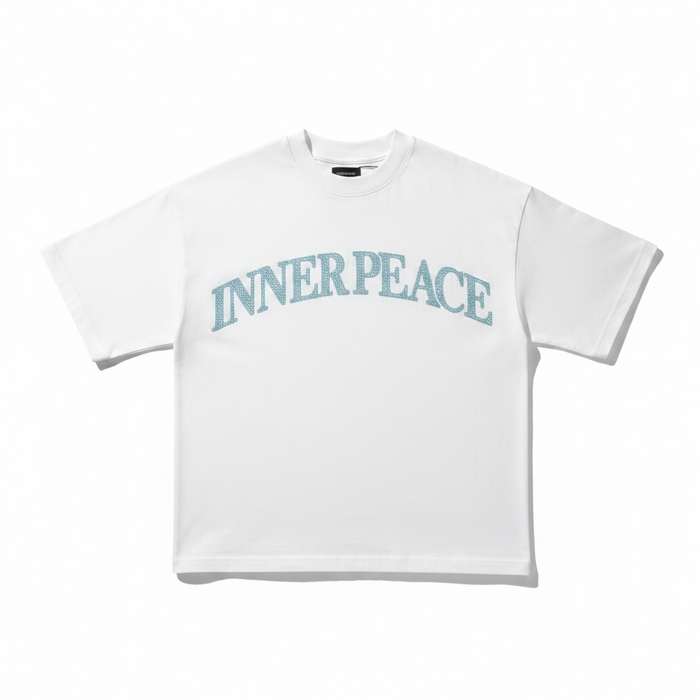Inner Peace white oversized rhinestone T-shirt with "Peace Everywhere" slogan, casual fit, and sparkling embellishments.