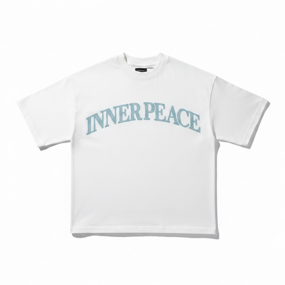 Inner Peace white oversized rhinestone T-shirt with "Peace Everywhere" slogan, casual fit, and sparkling embellishments.