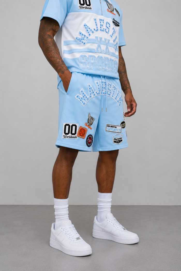 Light blue Majestik Champion rhinestone rugby patch shorts with stylish detailing and comfortable fit.