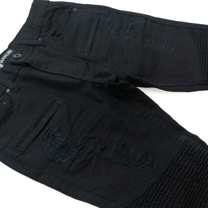 Makobi Kids Rick Biker black denim kids' jeans with distressed details and classic five-pocket design, shown on a child model.