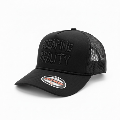 Black MUKA 'Escaping Reality' trucker hat with mesh back and curved brim, casual accessories for streetwear style.