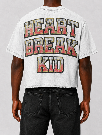 White Prestige Heart Break Kid cropped T-shirt featuring a graphic design, casual fit, and trendy style.