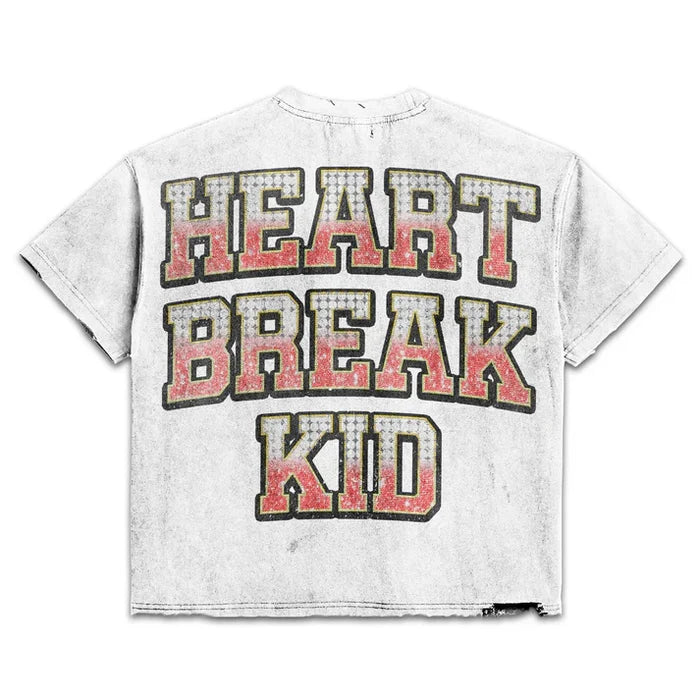 White Prestige Heart Break Kid cropped T-shirt featuring a graphic design, styled casually on a model.