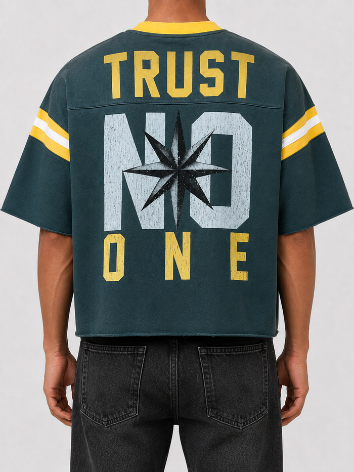 Rare Peace oversized rhinestone cropped French Terry T-shirt in pine green, featuring "Never Mind" design on the back.