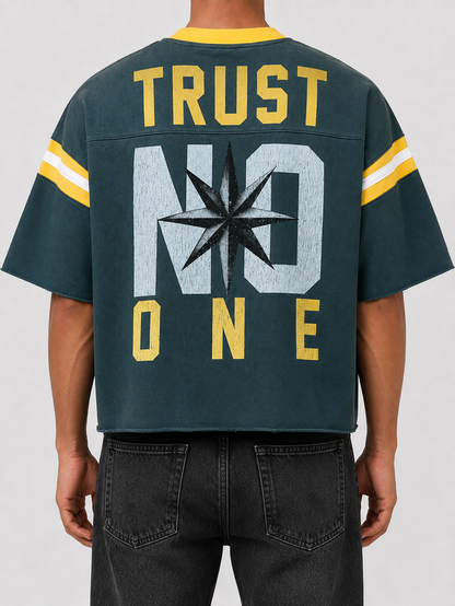 Rare Peace oversized rhinestone cropped French Terry T-shirt in pine green, featuring "Never Mind" design on the back.