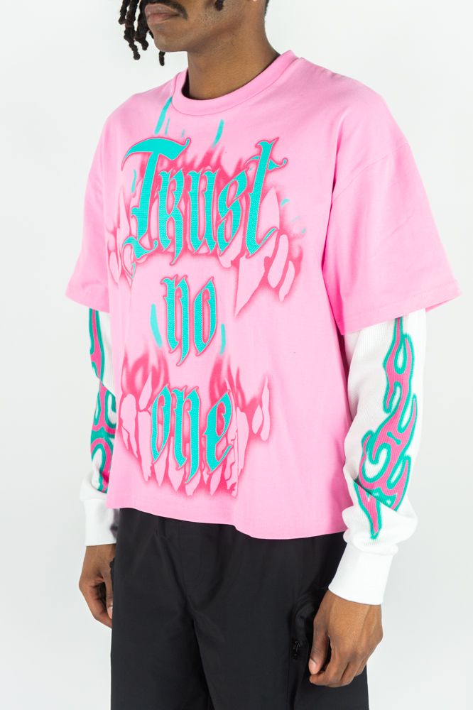 Pink long sleeve T-shirt from Rebel Minds with "Trust No One" graphic print, featuring casual, comfortable style.