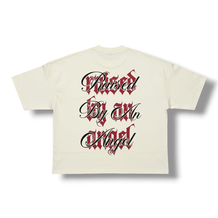 Cream oversized cropped T-shirt by Silent Verse featuring the "Raised By An Angel" design, casual and stylish for everyday wear.