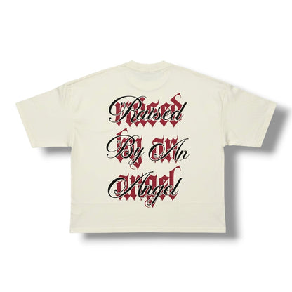 Cream oversized cropped T-shirt by Silent Verse featuring the "Raised By An Angel" design, casual and stylish for everyday wear.