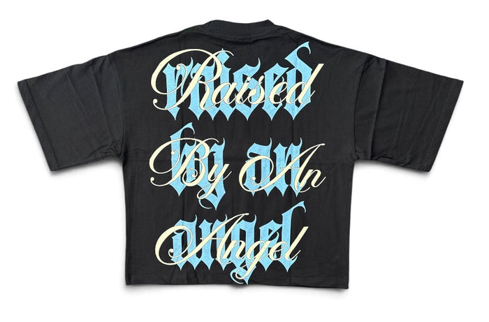 Black Silent Verse Raised By An Angel oversized cropped T-shirt featuring bold graphic design and relaxed fit.