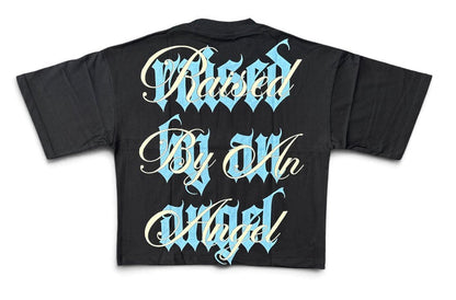 Black Silent Verse Raised By An Angel oversized cropped T-shirt featuring bold graphic design and relaxed fit.