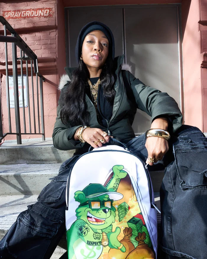 Sprayground Money Bear Stash backpack in black with colorful graphic design, featuring a front zipper pocket and adjustable straps.