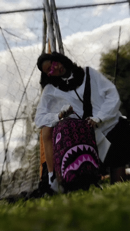 Sprayground Money Maker Shark Paper backpack featuring a bold shark design and vibrant colors, perfect for accessories and everyday use.