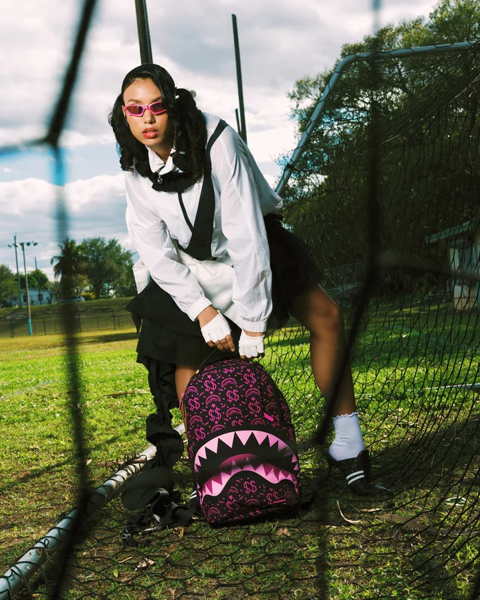 Sprayground Money Maker Shark Paper backpack featuring a vibrant shark design and bold accessories, made of durable materials.