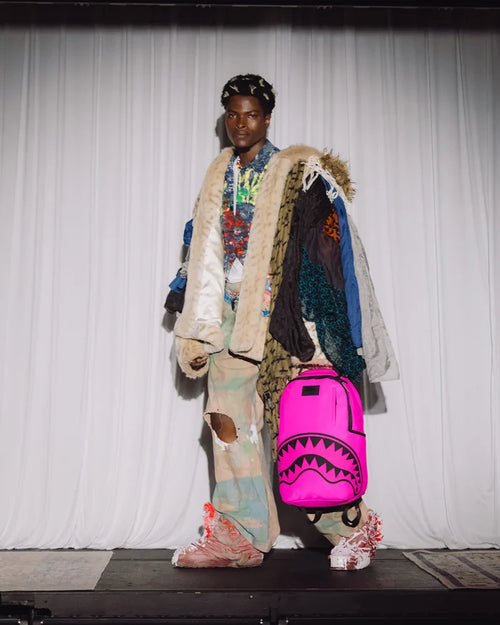 Sprayground Shark Central 2 Pink Code backpack with shark graphic, accessories, and adjustable straps, vibrant and stylish.